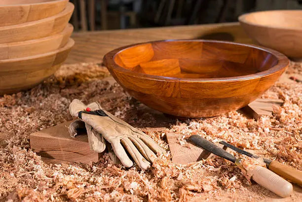 artisan shaping a wooden bowl in a calm workshop