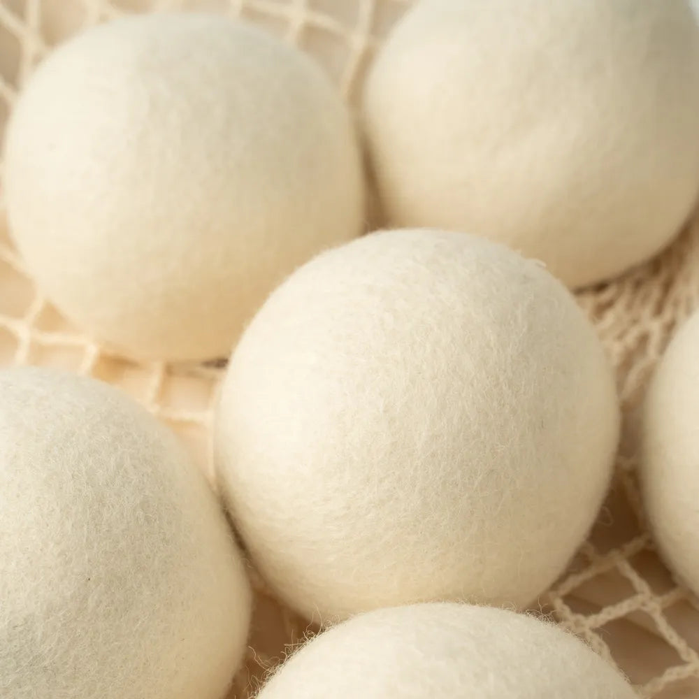 Reusable wool dryer balls arranged for everyday laundry care