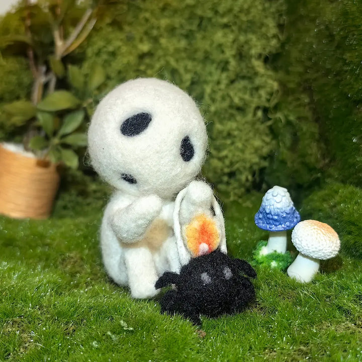 Lantern Sprite wool felt figurine with a black spider lantern in a mossy woodland scene