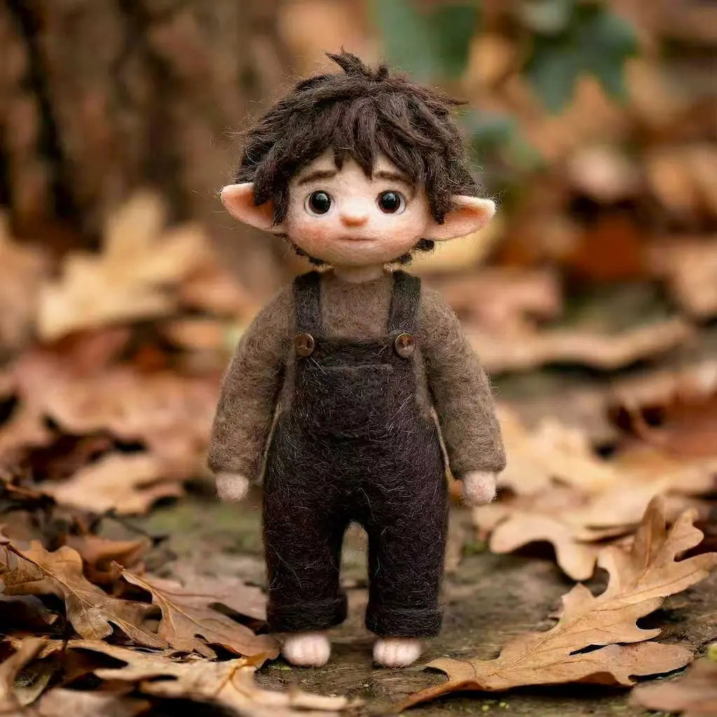 Small figurine with pointed ears standing on a leaf-covered ground