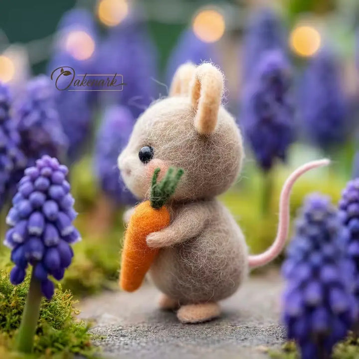 Felted mouse holding a carrot among purple flowers