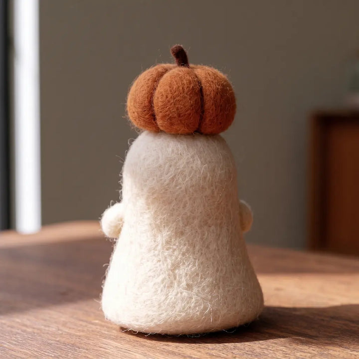 Rear view of the Pumpkin Crown Ghost figurine, showing natural ivory wool fibers and the ridged pumpkin crown.
