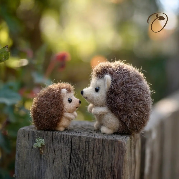 Two toy hedgehogs on a wooden stump with a blurred natural background