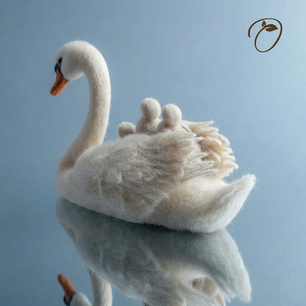 Felted white swan on a blue background