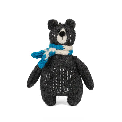 Toy bear with a blue and white striped scarf on a white background