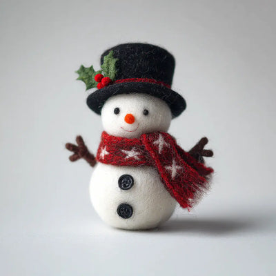 Small snowman figurine with a red scarf, black top hat with holly, and white background