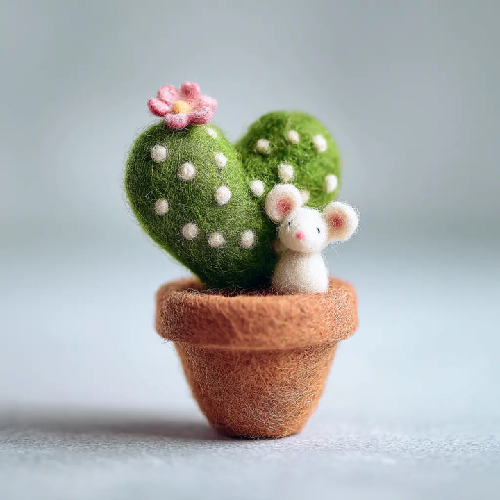 Felted cactus and mouse in a pot on a light background
