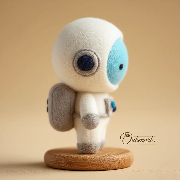 Small astronaut felt toy with a wooden base on a beige background