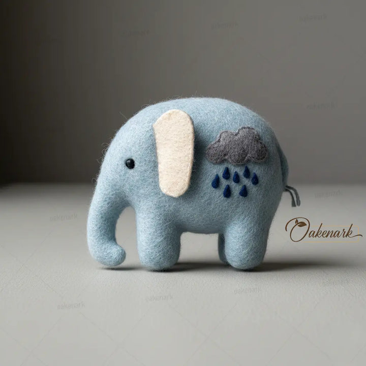 Blue elephant plush toy with cloud and raindrop design on a gray background, featuring the brand &