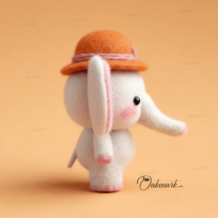 Toy elephant with an orange hat on a beige background, featuring the brand &
