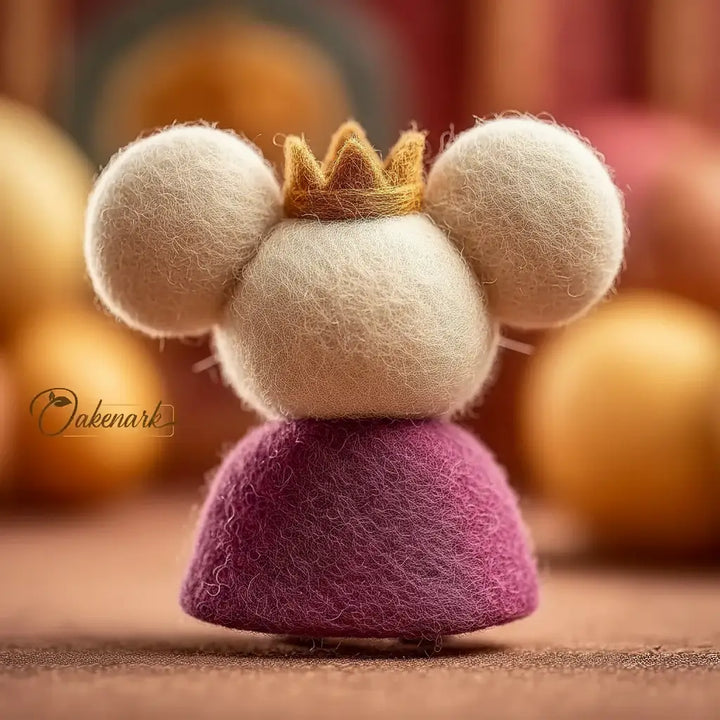 Felted decorative item resembling a character with a crown on a blurred background