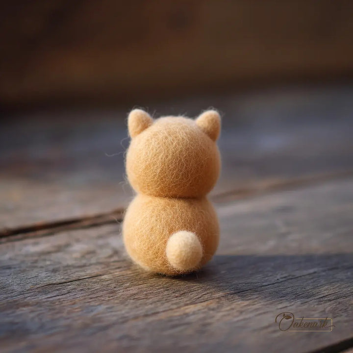 Small brown teddy bear toy on a wooden surface with a blurred background
