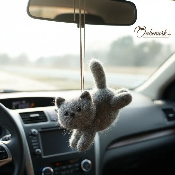 Plush cat toy hanging from a car&