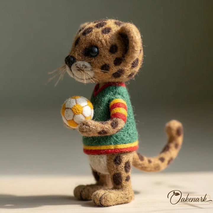 Stuffed toy leopard holding a soccer ball with a green background