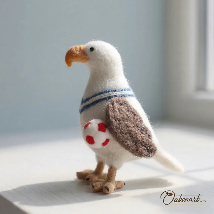 Stuffed toy eagle with a striped chest and red heart design on a light surface.