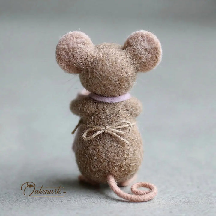 Textured mouse figure with a bow on a gray background