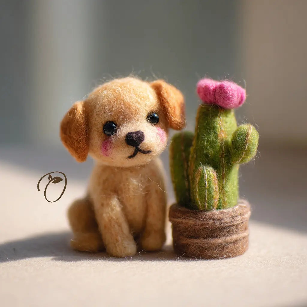 Felted toy dog sitting next to a felted cactus with pink flower on a neutral background