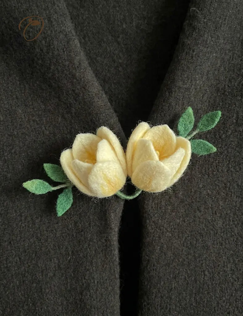 Yellow flower brooch on a dark fabric background