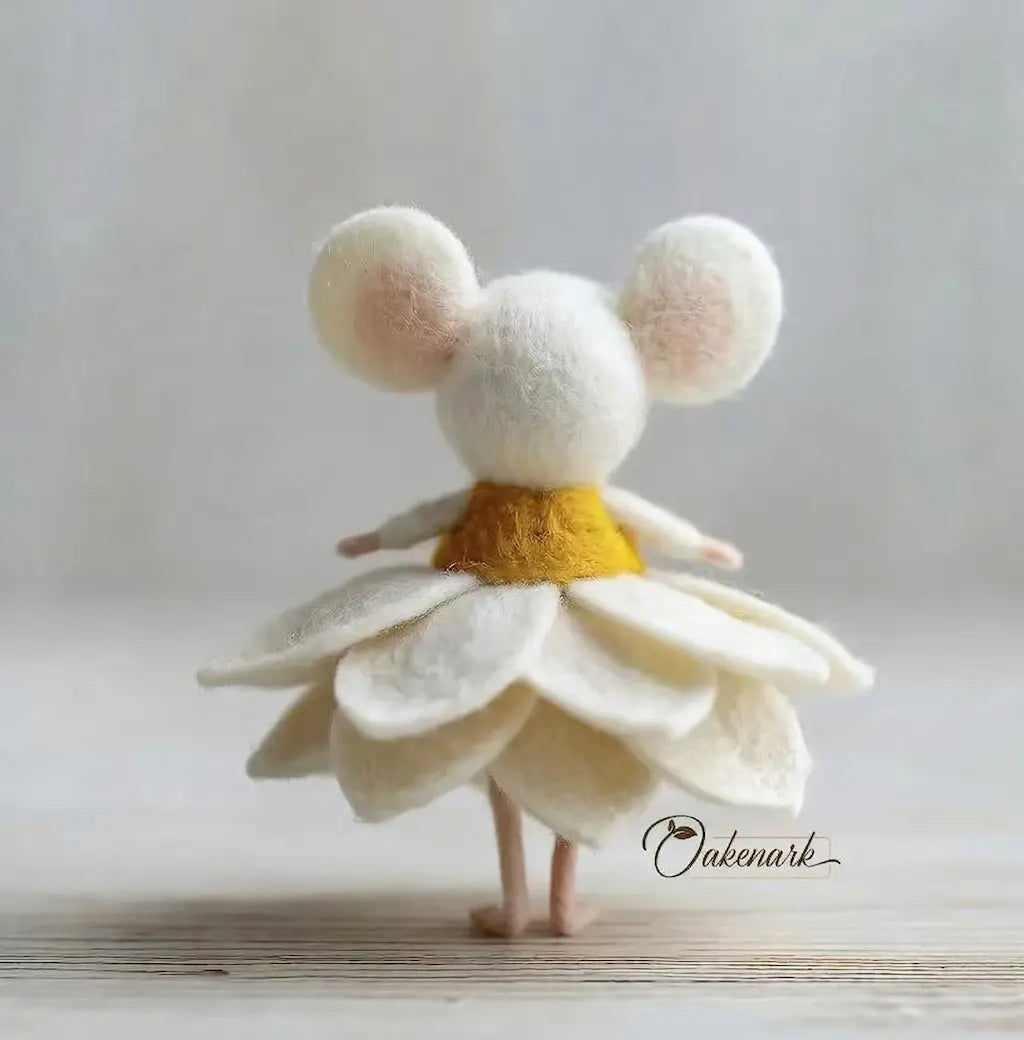 Toy figure with mouse ears and a white dress on a light background