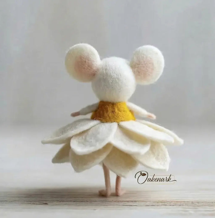 Toy figure with mouse ears and a white dress on a light background