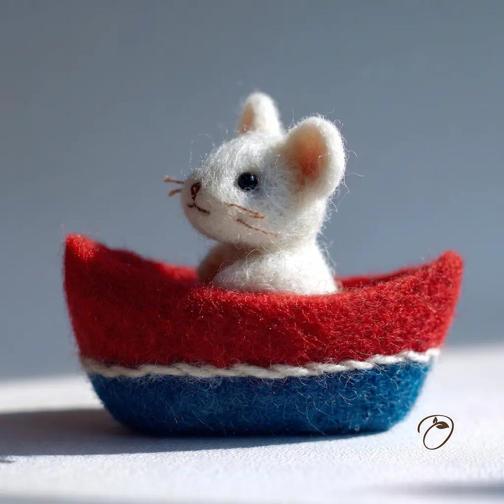 White mouse figurine in a red and blue boat on a light gray background