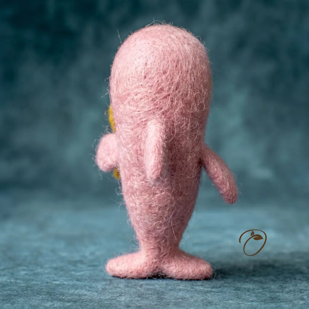 Pink textured figurine on a blue background