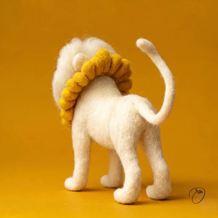 White lion toy with a yellow mane on an orange background