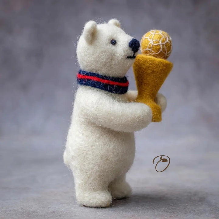 White bear figurine holding a golden trophy against a gray background
