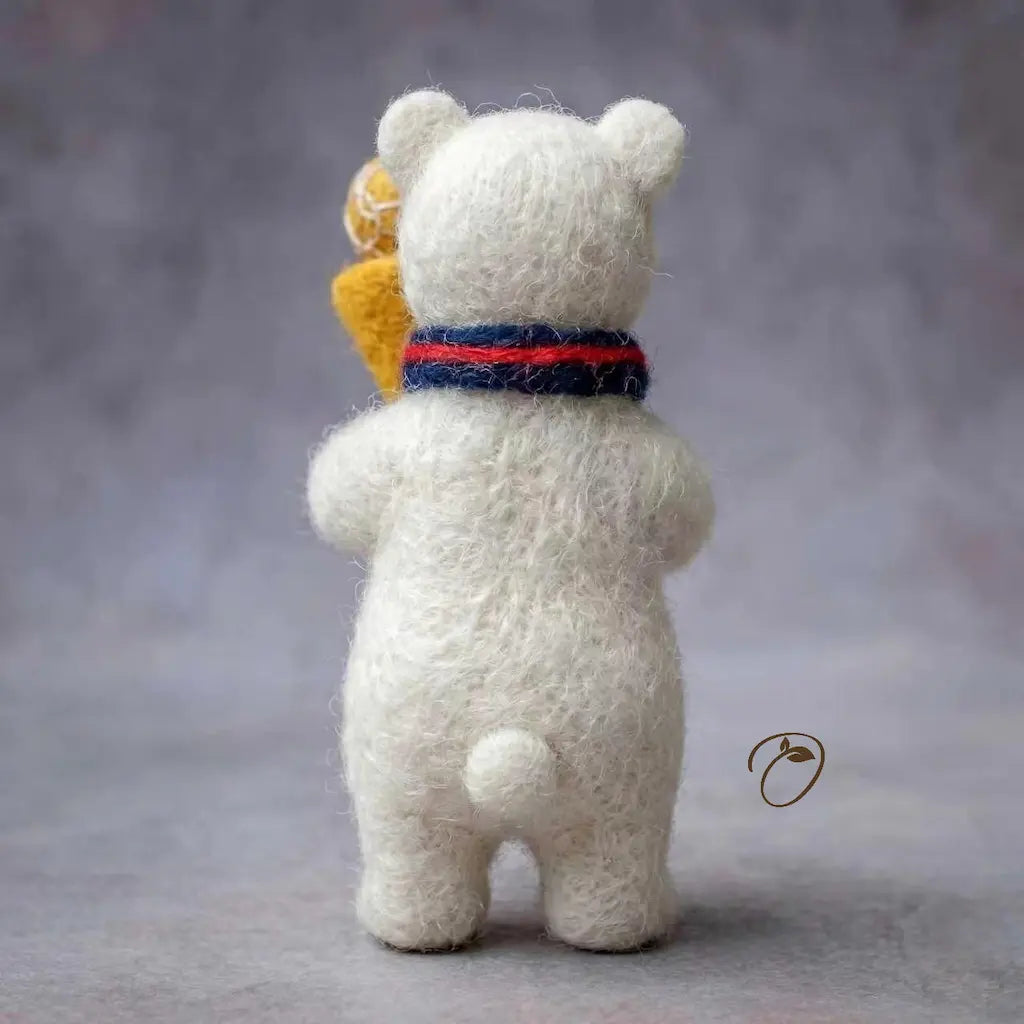 White teddy bear with a colorful scarf on a gray background