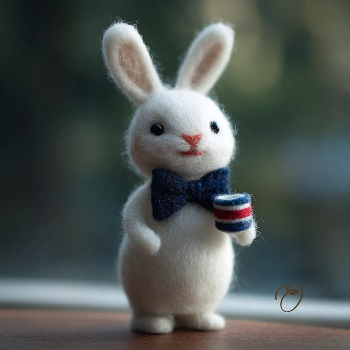 White rabbit figurine with a bow tie and striped cup on a blurred background