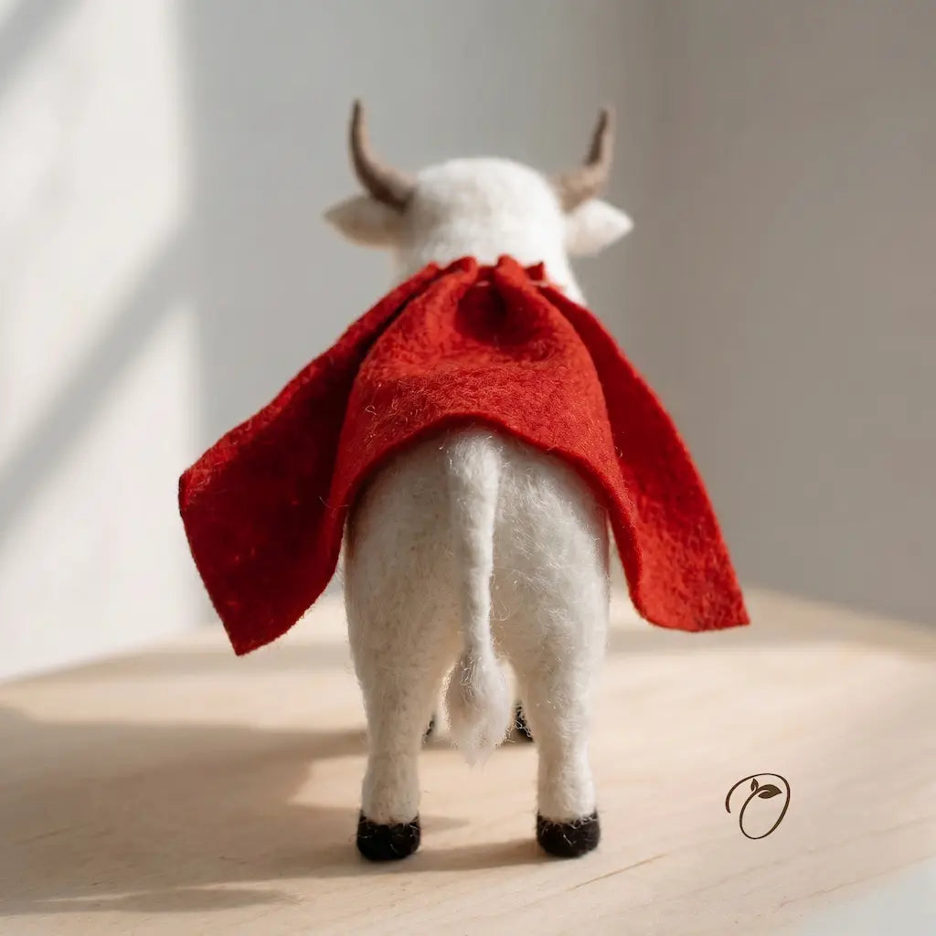 Felted white bull with a red coat