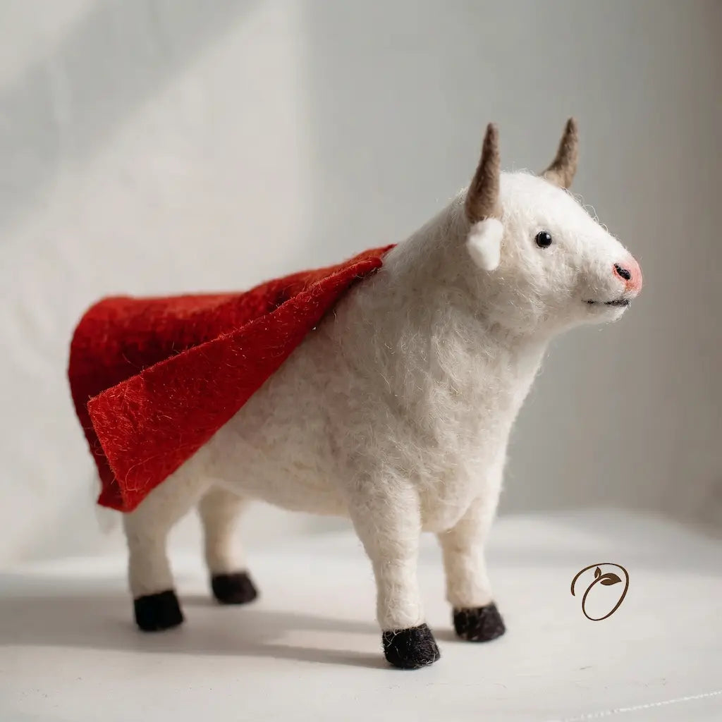 Felted white bull with a red coat