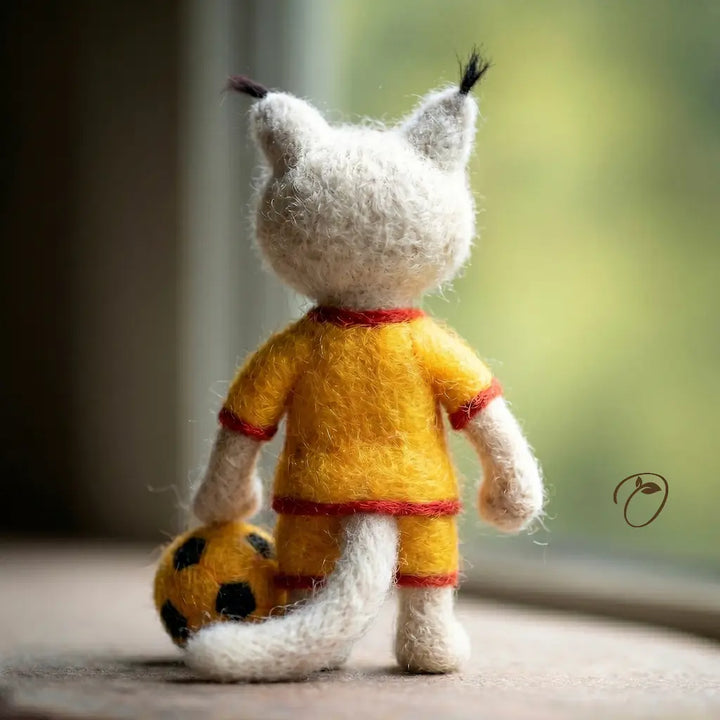 Toy figure of a character in a yellow outfit with a ball, standing indoors.