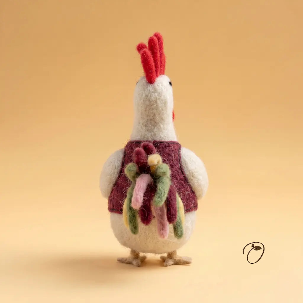 Knitted rooster toy with a colorful scarf on a beige background