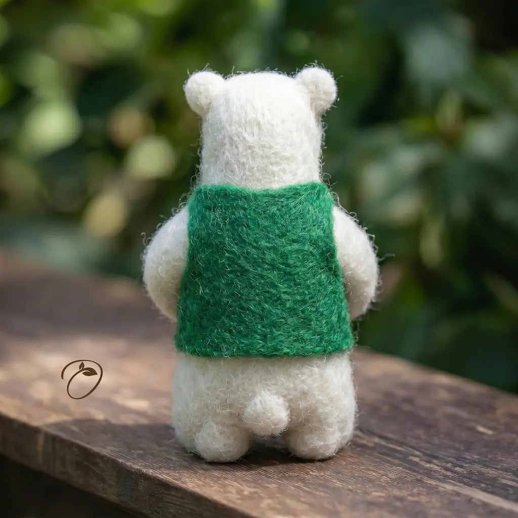 White bear plush toy with a green backpack on a wooden surface with a blurred natural background