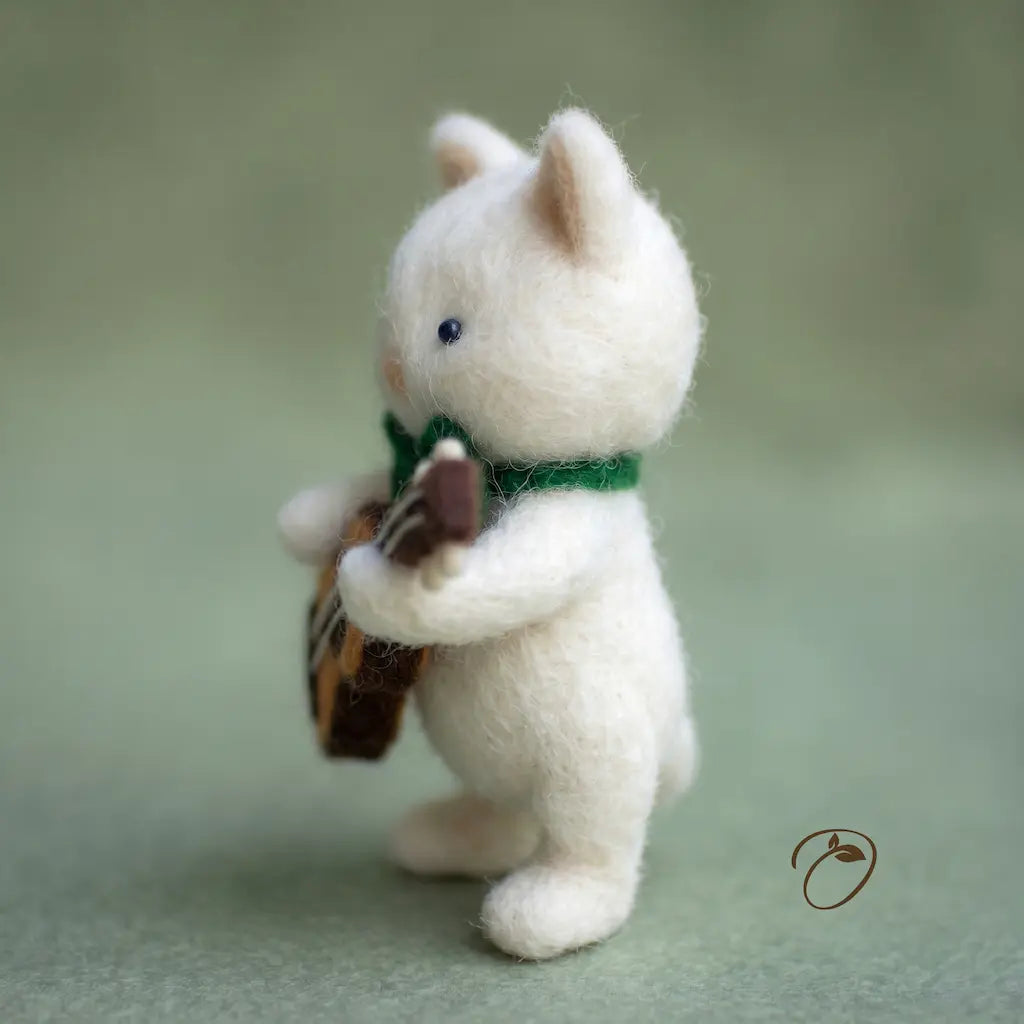 White cat figurine holding a brown bag on a light green background