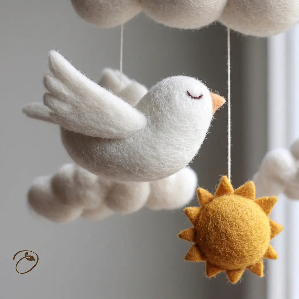 Felted bird, clouds, and sun hanging mobile against a neutral background