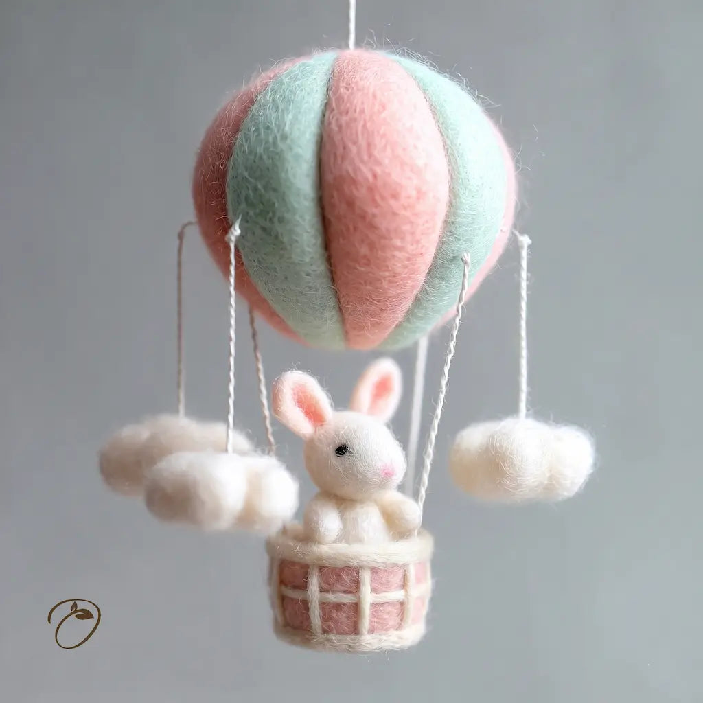 Toy rabbit in a pink and green hot air balloon with clouds on a gray background