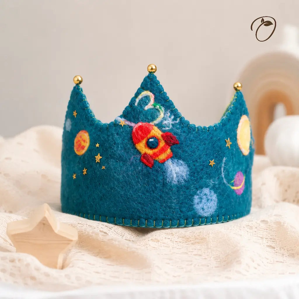 Children's felted crown with space design on a soft surface