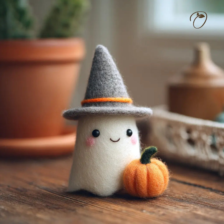 Toy ghost with a witch hat and pumpkin on a wooden surface