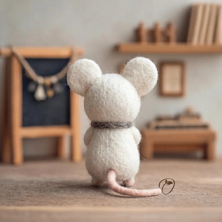 White mouse figurine on a wooden surface with a blurred indoor setting