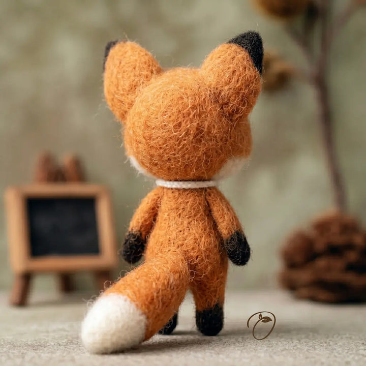Handmade fox plush toy with a blurred background