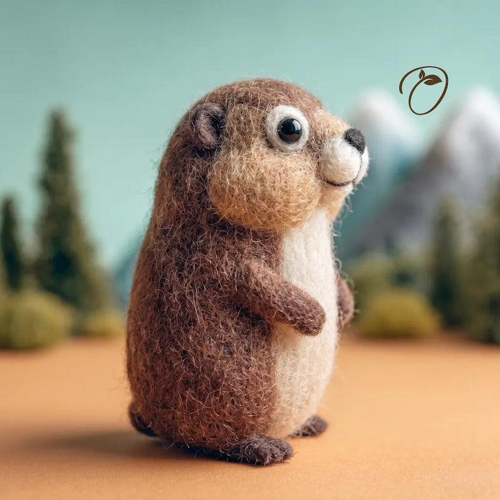 Stuffed animal groundhog standing on a brown surface with a blurred natural background