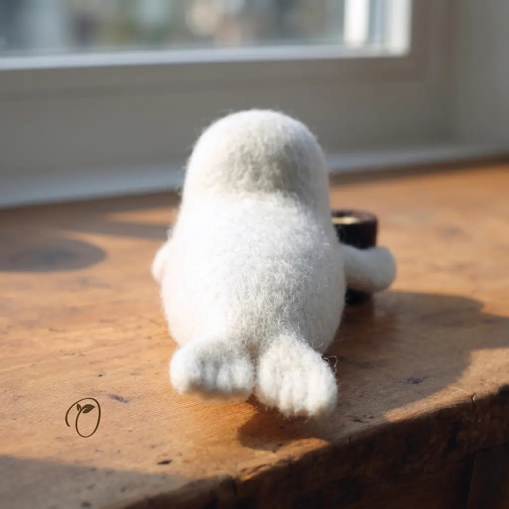 White plush toy on a wooden surface with sunlight casting shadows