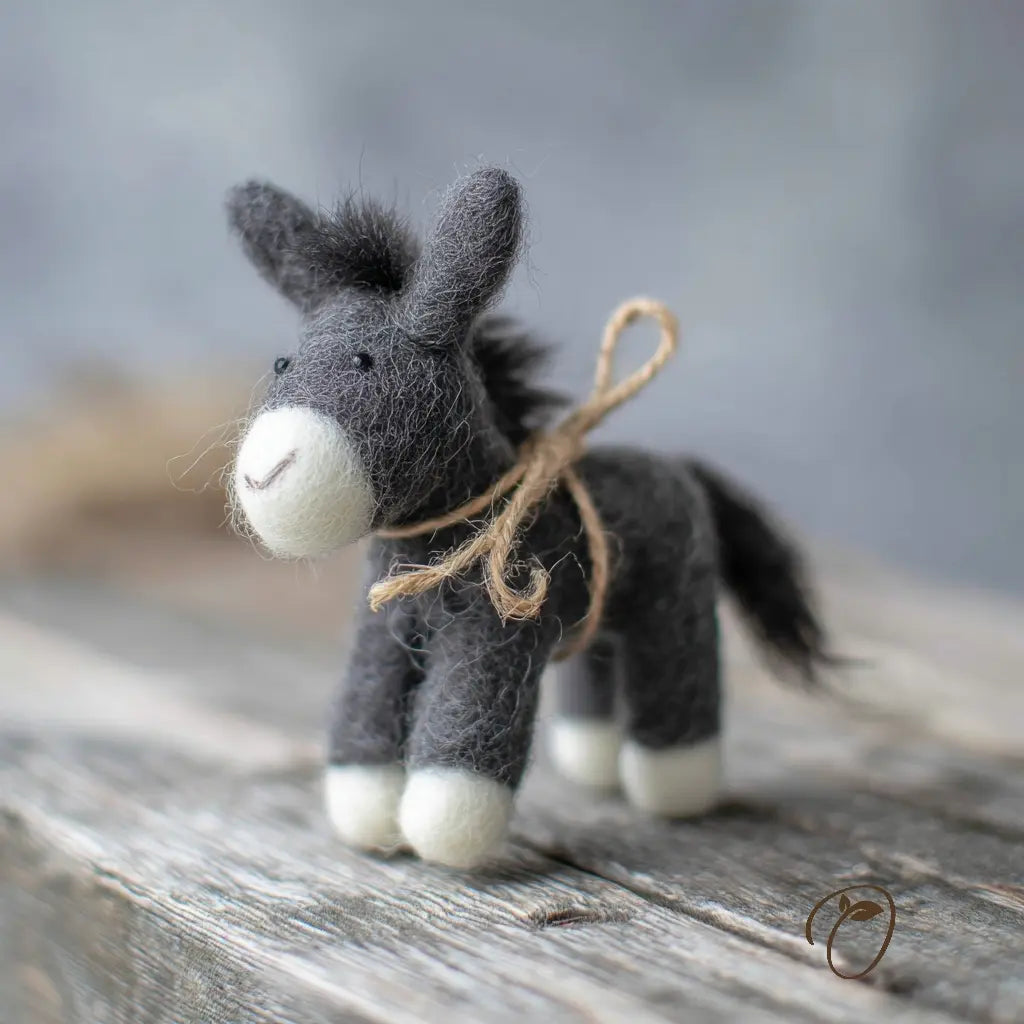 Textured donkey figurine with twine on a wooden surface