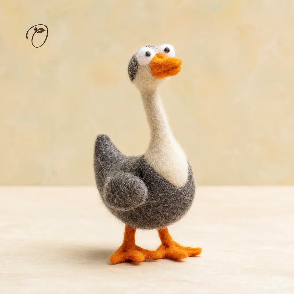 Felted goose toy on a beige background