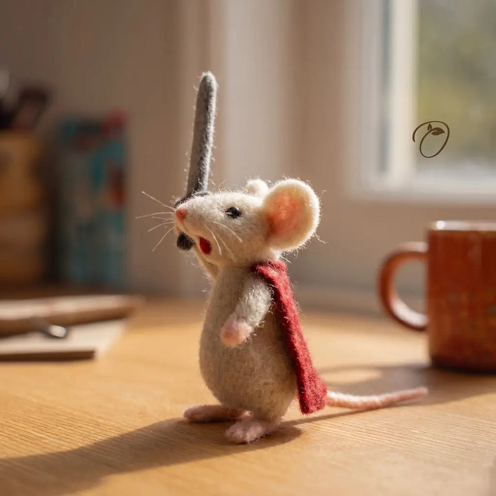 Felted mouse figurine with a red scarf on a wooden surface