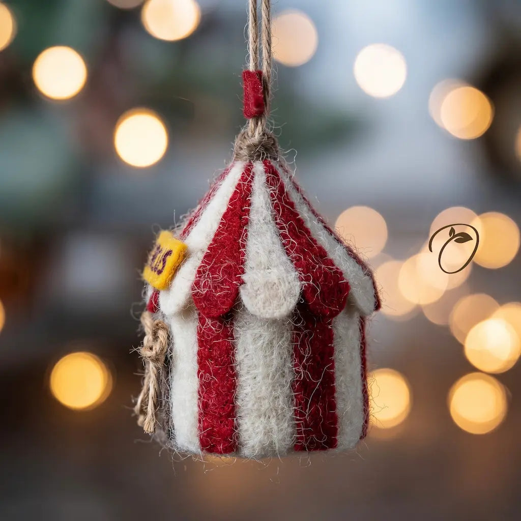 Decorative striped house ornament with a blurred festive background
