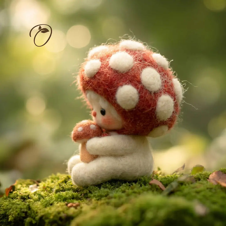 Stuffed toy resembling a mushroom with a white cap and red stem on a green mossy background