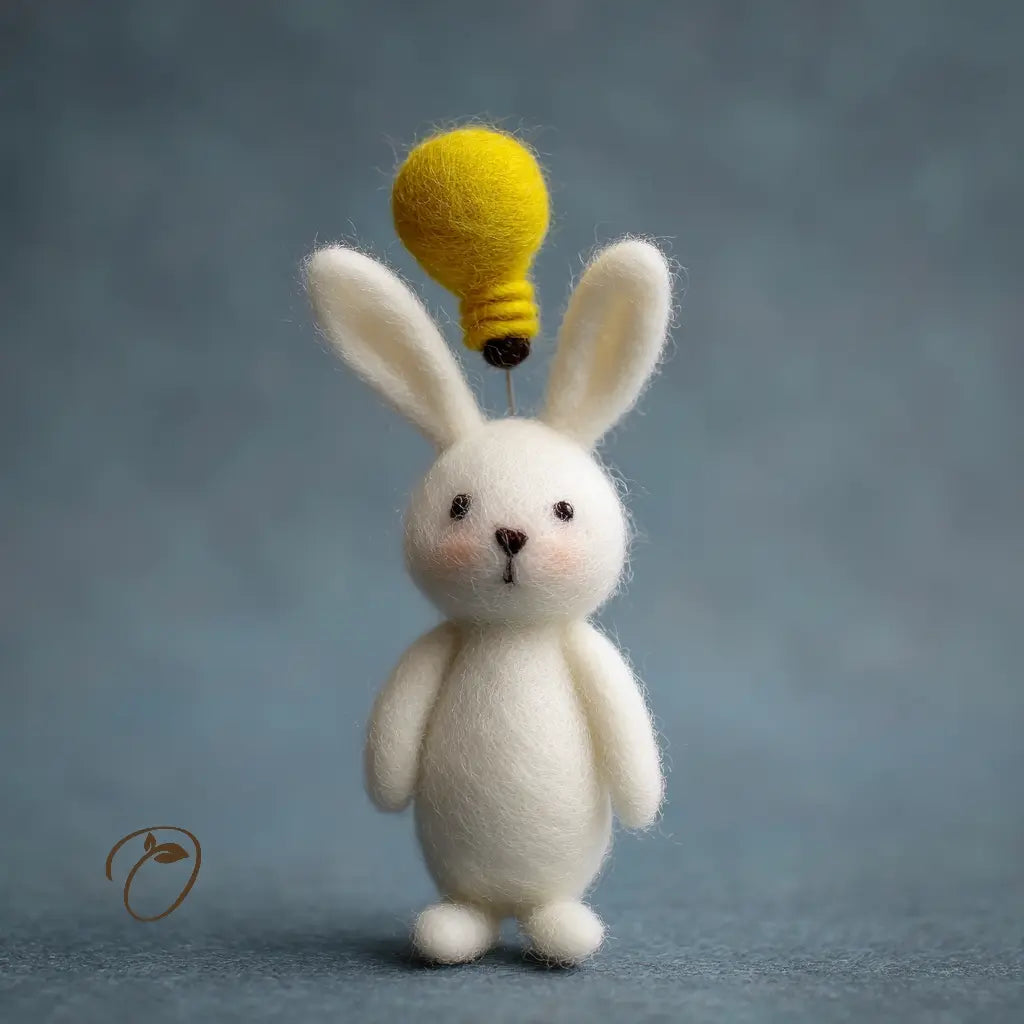 White rabbit figurine with a yellow light bulb on its head against a gray background